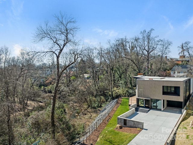 exterior space with concrete driveway and a front lawn