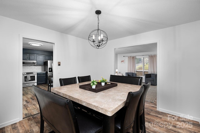 dining room with a textured ceiling, dark hardwood / wood-style floors, and a chandelier