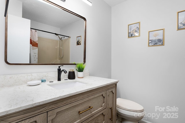 bathroom featuring vanity, toilet, and a shower with shower curtain