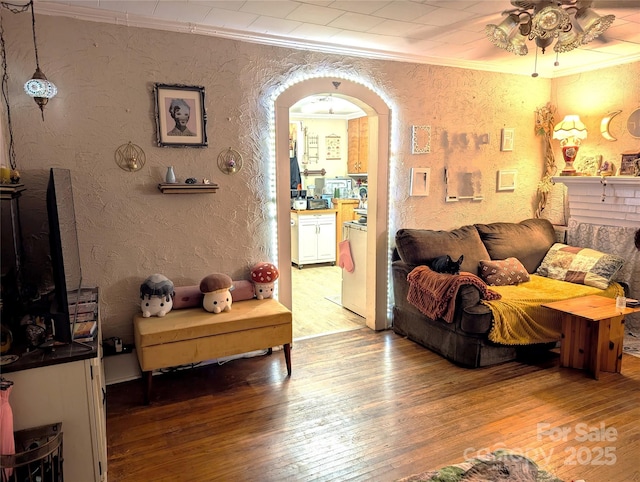 interior space featuring hardwood / wood-style flooring, ornamental molding, and ceiling fan