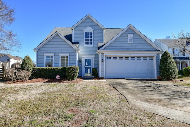 view of front of home featuring a garage and a front yard