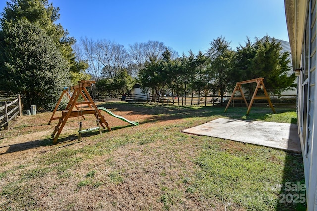 view of play area featuring a patio and a lawn