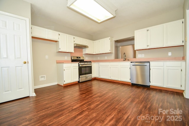 kitchen with appliances with stainless steel finishes, dark hardwood / wood-style flooring, and white cabinets