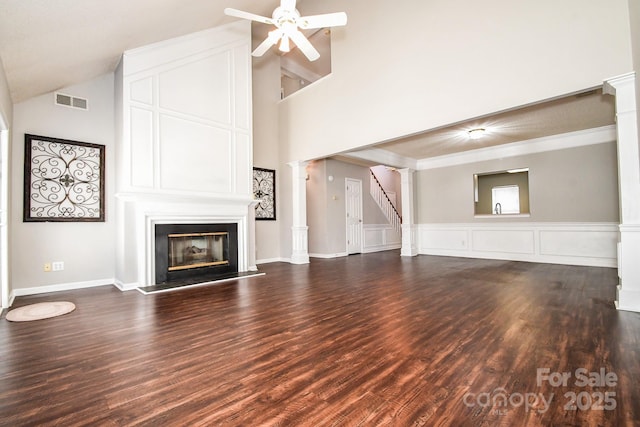 unfurnished living room with dark hardwood / wood-style floors, ceiling fan, and ornate columns