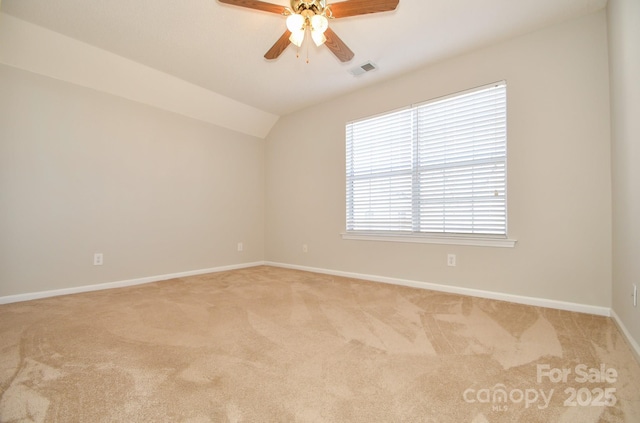 carpeted empty room featuring lofted ceiling and ceiling fan