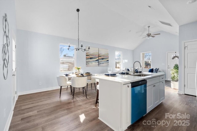 kitchen with sink, white cabinetry, a center island with sink, decorative light fixtures, and stainless steel dishwasher