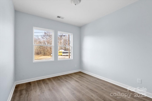 unfurnished room with wood-type flooring