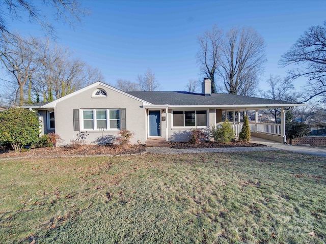 single story home with covered porch and a front lawn