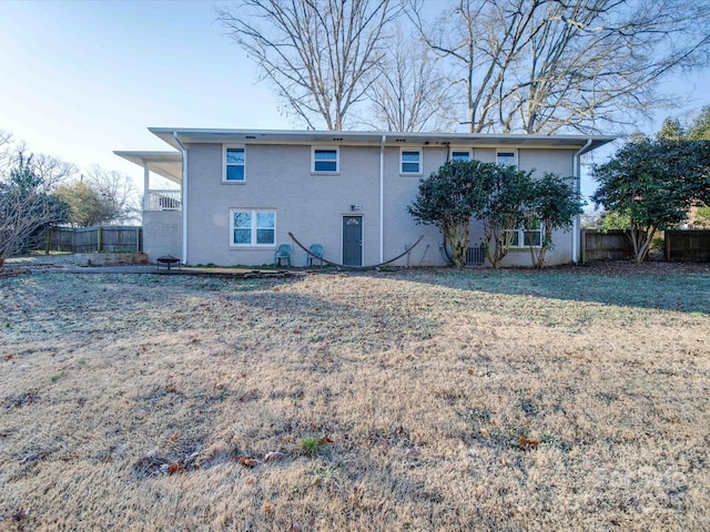 rear view of house featuring a lawn