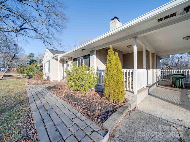 view of side of property featuring a porch