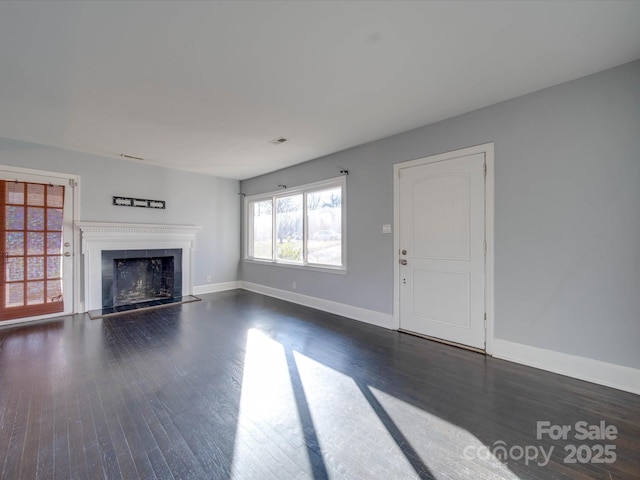 unfurnished living room with dark hardwood / wood-style floors