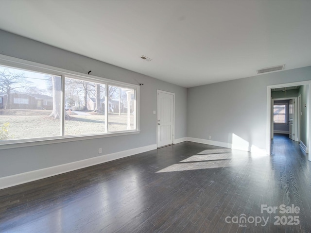 spare room featuring dark hardwood / wood-style floors