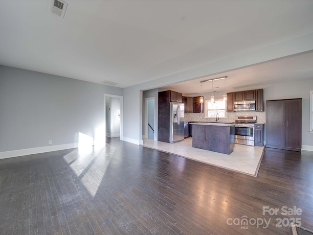 unfurnished living room featuring sink and light wood-type flooring