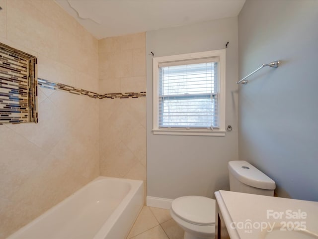 full bathroom featuring vanity, tiled shower / bath, tile patterned floors, and toilet