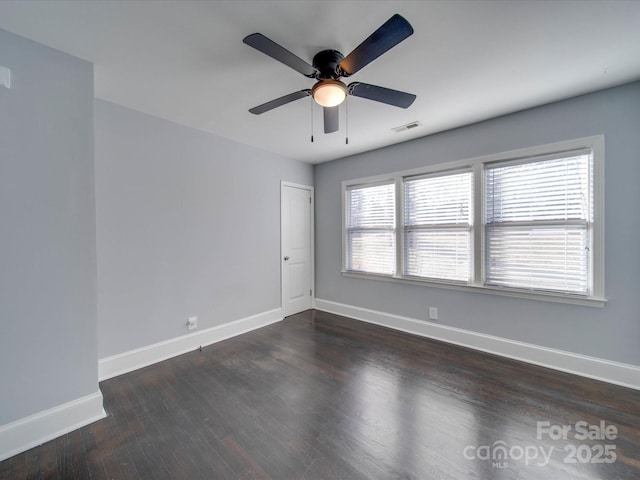 spare room featuring dark hardwood / wood-style flooring and ceiling fan