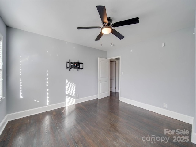 spare room with dark hardwood / wood-style floors and ceiling fan