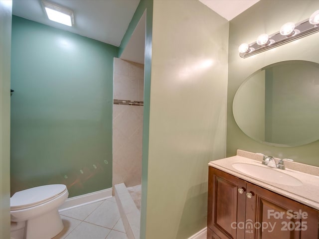 bathroom with tile patterned flooring, vanity, toilet, and walk in shower