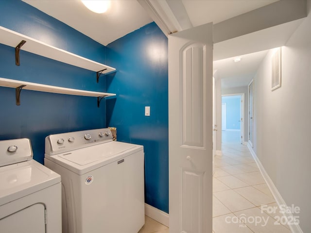 laundry room with separate washer and dryer and light tile patterned floors