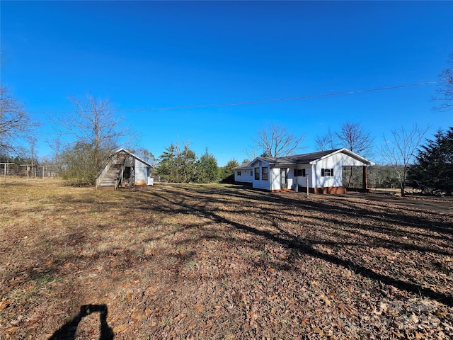 view of home's exterior with a storage shed and a yard