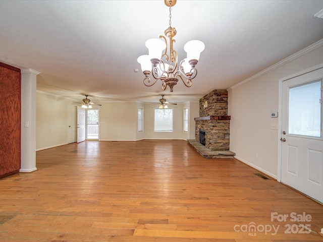 unfurnished living room featuring a fireplace, ornamental molding, light hardwood / wood-style floors, and plenty of natural light