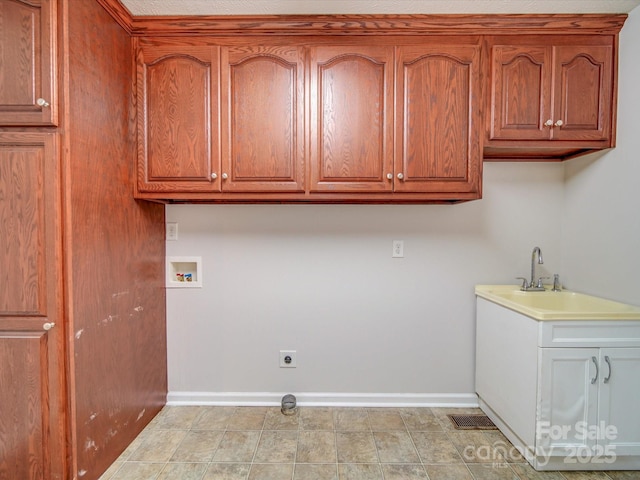 washroom featuring washer hookup, sink, cabinets, and hookup for an electric dryer