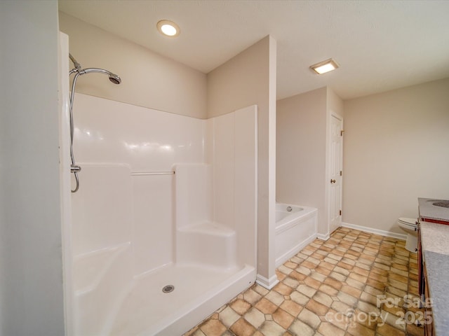 bathroom featuring plus walk in shower and toilet