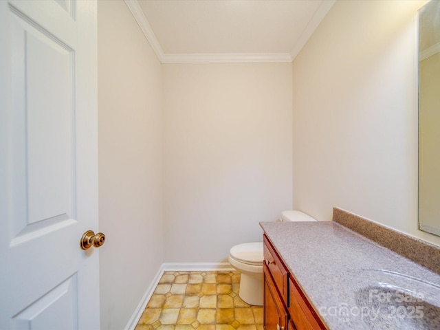 bathroom featuring vanity, ornamental molding, and toilet