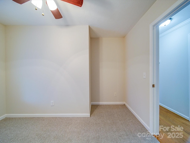 carpeted spare room with ceiling fan