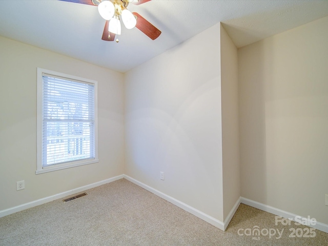 carpeted empty room featuring ceiling fan