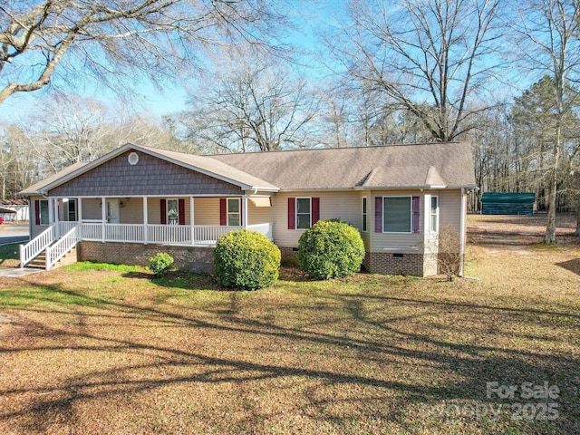 single story home featuring covered porch and a front yard