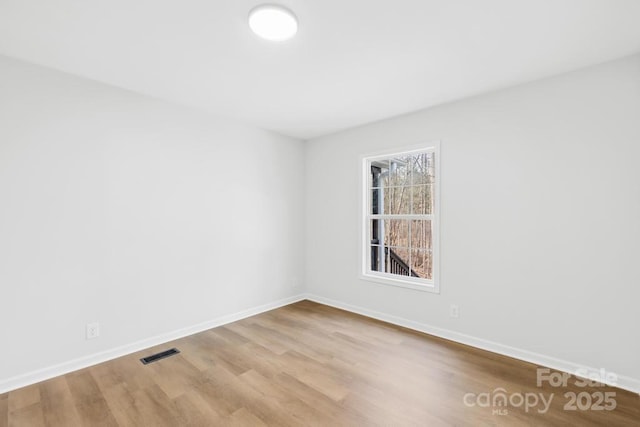 spare room featuring light hardwood / wood-style floors