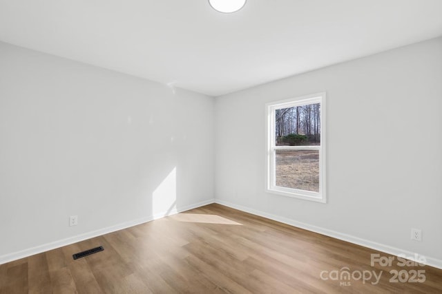 empty room with light hardwood / wood-style floors