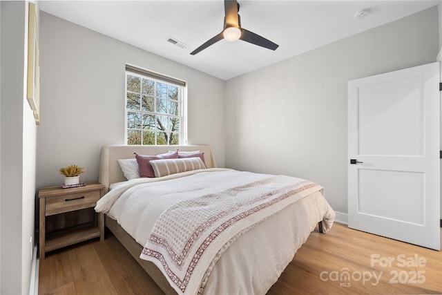 bedroom with hardwood / wood-style flooring and ceiling fan