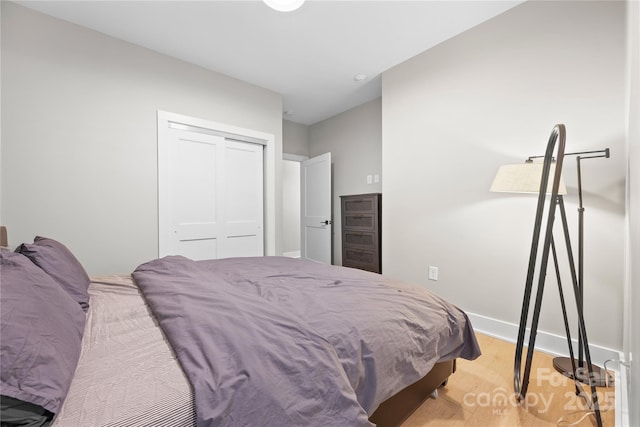 bedroom with a closet and light wood-type flooring