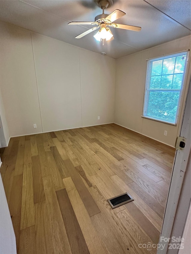 spare room featuring ceiling fan and light hardwood / wood-style floors