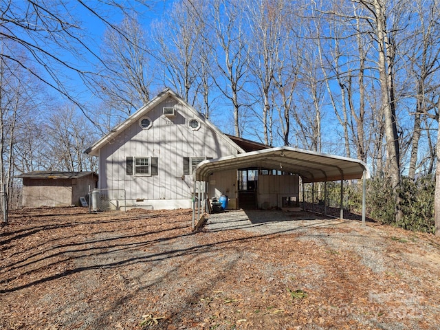 view of side of home with a carport