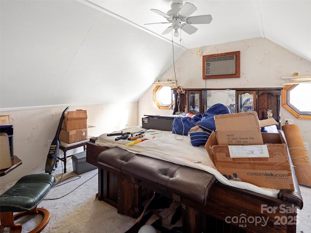 bedroom featuring ceiling fan, light colored carpet, vaulted ceiling, and a wall unit AC