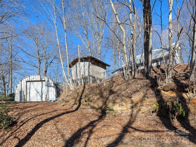 view of yard with a garage and an outdoor structure