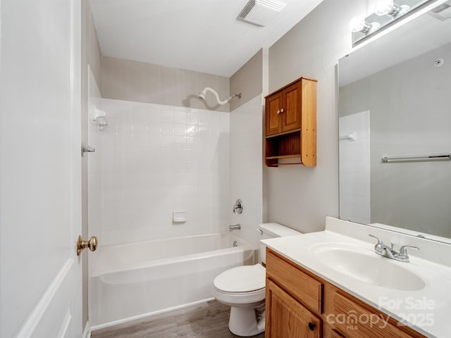 full bathroom with vanity, hardwood / wood-style floors, shower / bathtub combination, and toilet