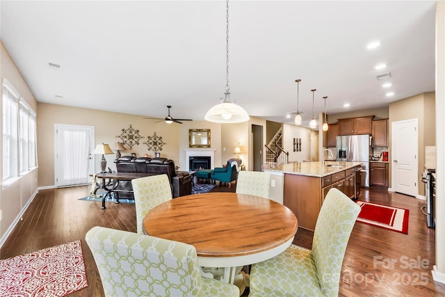 1605 Appledale Ct Unit 116, Fort Mill, SC 29715 - dining space featuring dark wood-style flooring, a lit fireplace, a ceiling fan, stairway, and recessed lighting