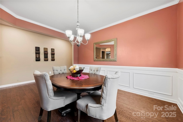 1605 Appledale Ct Unit 116, Fort Mill, SC 29715 - dining area featuring a chandelier, crown molding, dark wood-style floors, and a wainscoted wall