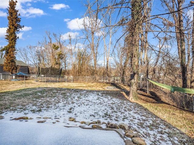 snowy yard featuring a trampoline