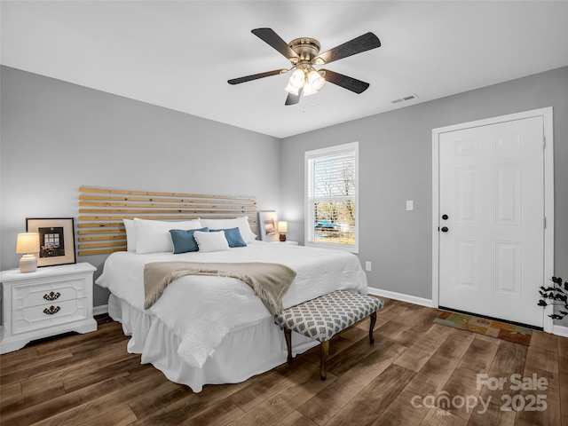 bedroom with dark hardwood / wood-style floors and ceiling fan