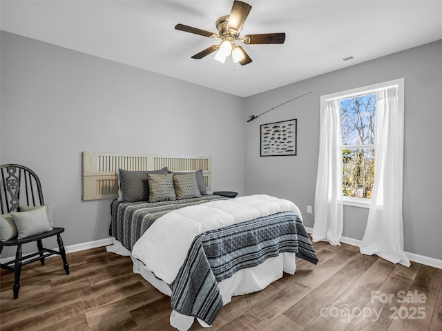 bedroom with dark wood-type flooring and ceiling fan