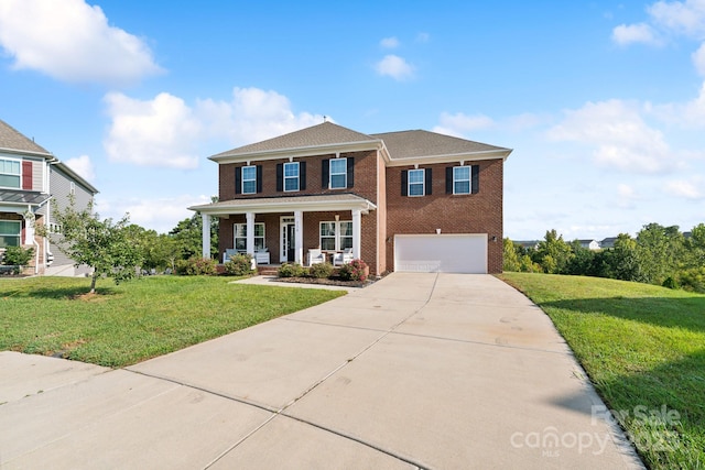 view of front of home with a garage, covered porch, and a front lawn