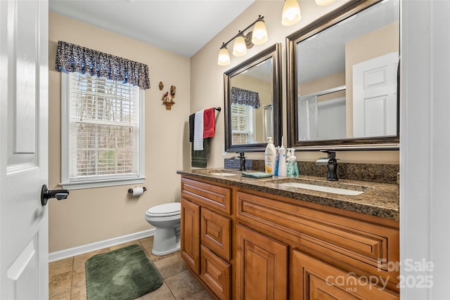 bathroom featuring vanity, tile patterned flooring, a shower with door, and toilet