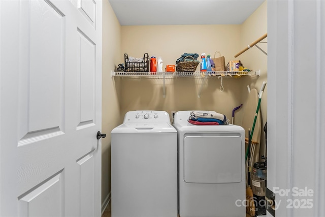 washroom featuring washer and clothes dryer