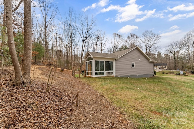 view of side of home featuring a yard and a sunroom