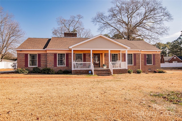 single story home with a front lawn and covered porch