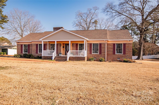 ranch-style house with covered porch and a front lawn